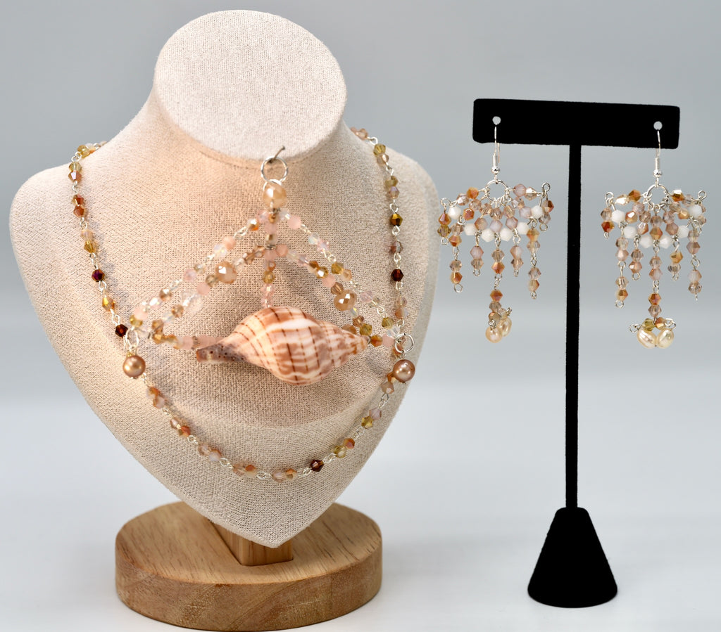Jewelry set with necklace and earrings on a mannequin and stand.